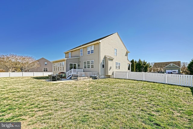 back of property with a patio area, a lawn, and a fenced backyard