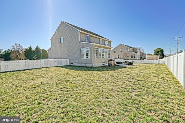 rear view of property with a lawn, a fenced backyard, and a patio area