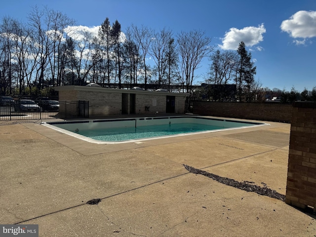 pool featuring a patio area and fence