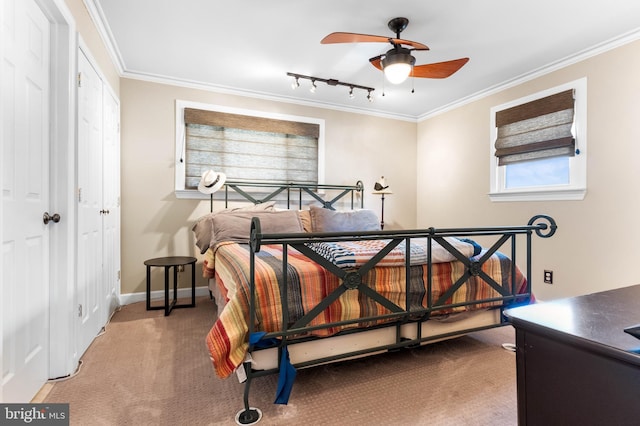 carpeted bedroom with baseboards, a ceiling fan, ornamental molding, and track lighting