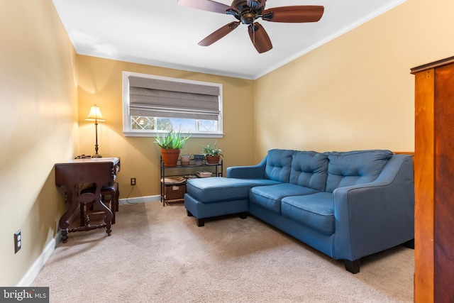 living room with crown molding, carpet flooring, a ceiling fan, and baseboards