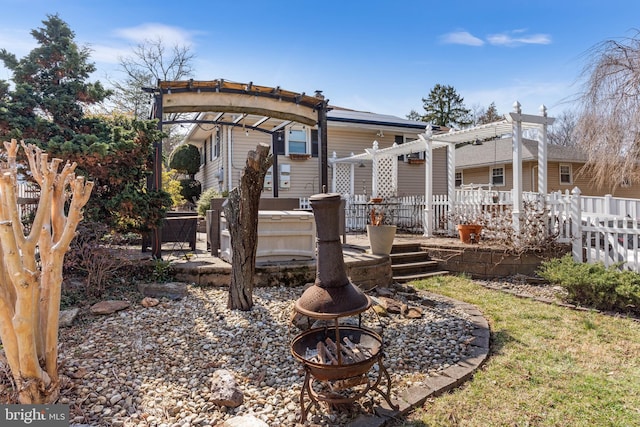 view of yard with a fire pit, a pergola, a deck, and fence