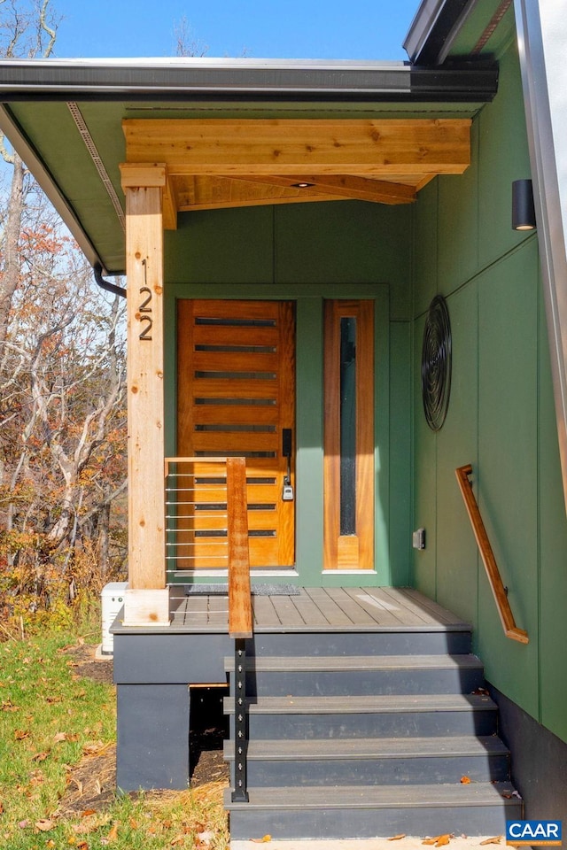 view of exterior entry with a porch