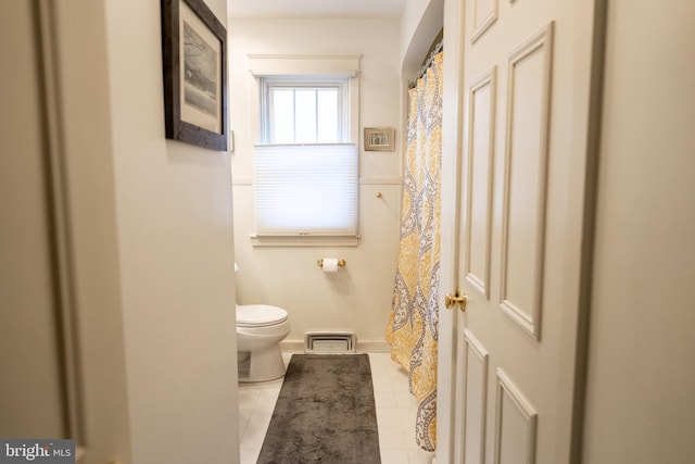 full bath featuring toilet and tile patterned flooring