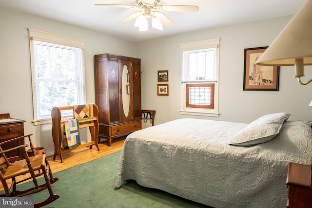 bedroom with wood finished floors and a ceiling fan