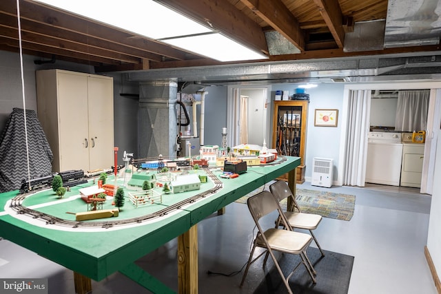 dining space featuring washer and clothes dryer and concrete floors