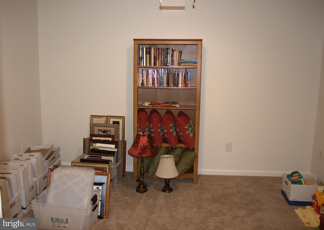 recreation room featuring baseboards and carpet floors