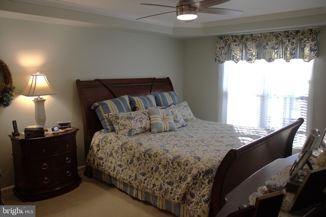 bedroom featuring ceiling fan, carpet floors, and ornamental molding