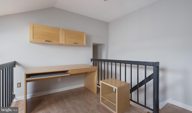 home office with vaulted ceiling, wood finished floors, and baseboards