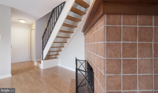 staircase with wood finished floors and baseboards