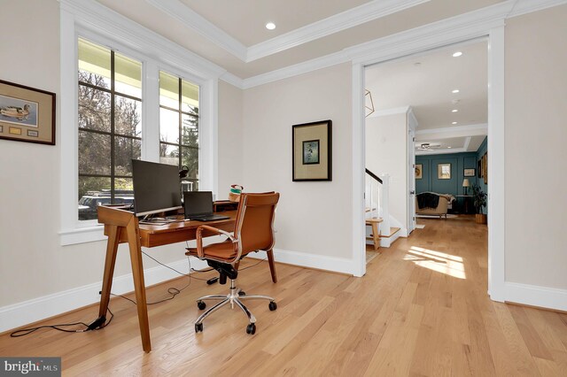 office area featuring baseboards, wood finished floors, ornamental molding, and a healthy amount of sunlight