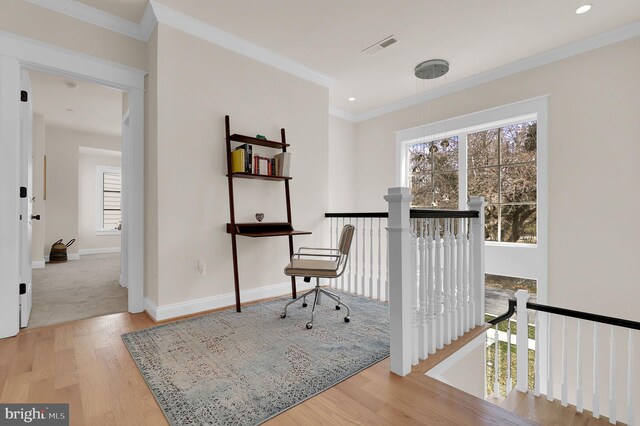 sitting room featuring ornamental molding, an upstairs landing, baseboards, and wood finished floors