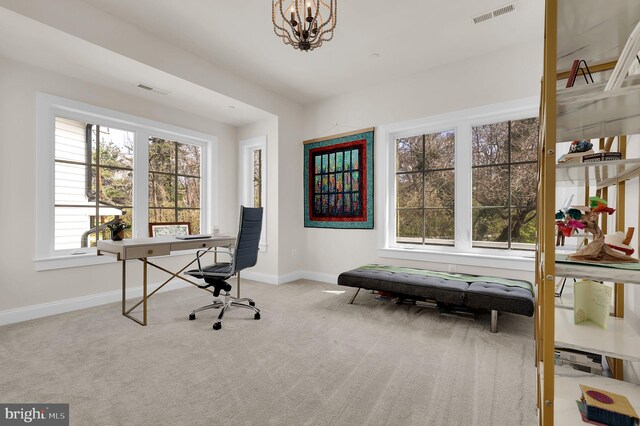 office area featuring an inviting chandelier, carpet floors, baseboards, and visible vents