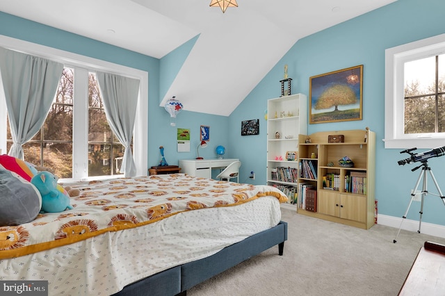 carpeted bedroom with baseboards and vaulted ceiling