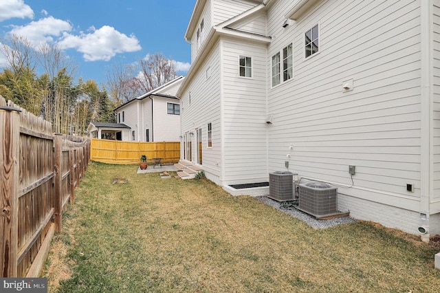 exterior space featuring central air condition unit, a lawn, entry steps, and a fenced backyard