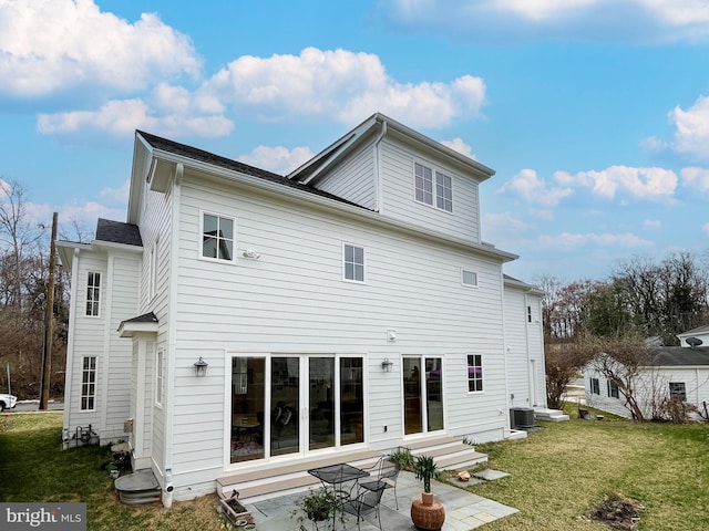 back of house featuring a lawn, central air condition unit, entry steps, and a patio area