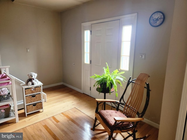 entrance foyer with light wood finished floors and baseboards