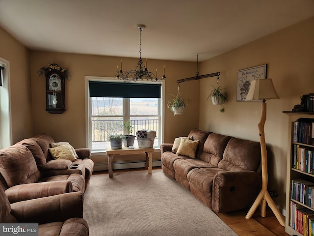 living area with an inviting chandelier and baseboard heating