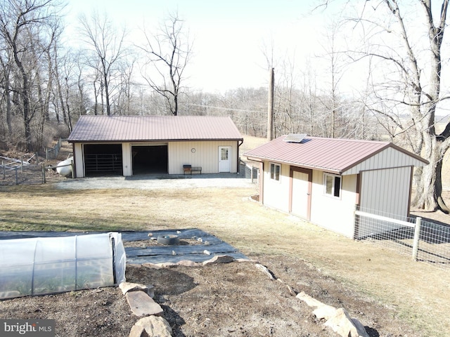 view of outdoor structure featuring an outbuilding and fence