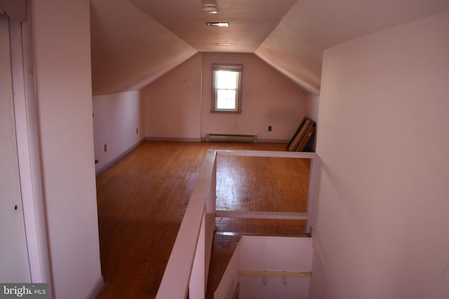 bonus room featuring baseboard heating, lofted ceiling, and wood-type flooring