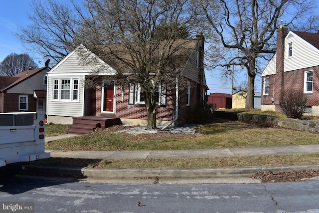 bungalow-style home featuring brick siding