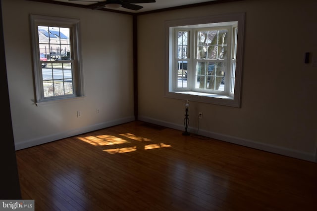 unfurnished room featuring baseboards, wood-type flooring, and ceiling fan