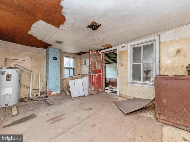 interior space with visible vents and electric water heater