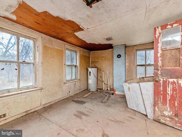 interior space with visible vents, a healthy amount of sunlight, and water heater