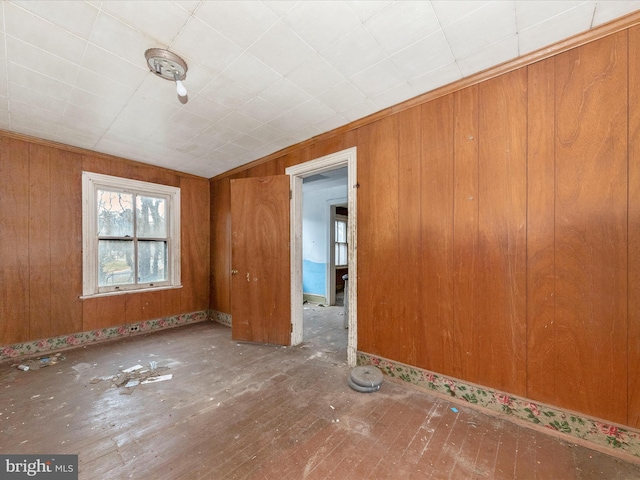 unfurnished room featuring wood walls and vaulted ceiling