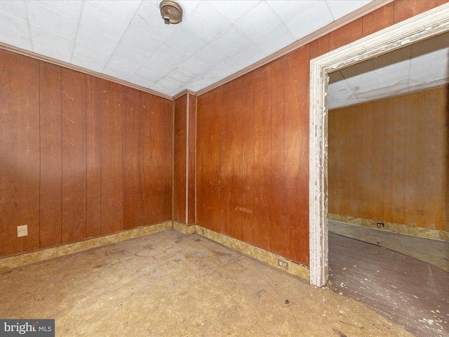 empty room featuring wood walls