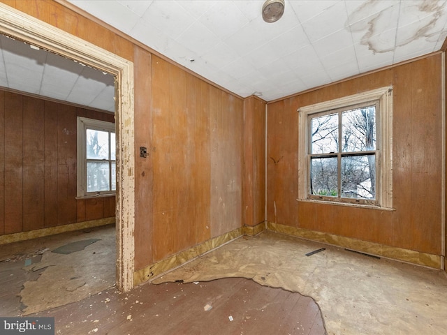 empty room with wooden walls and visible vents