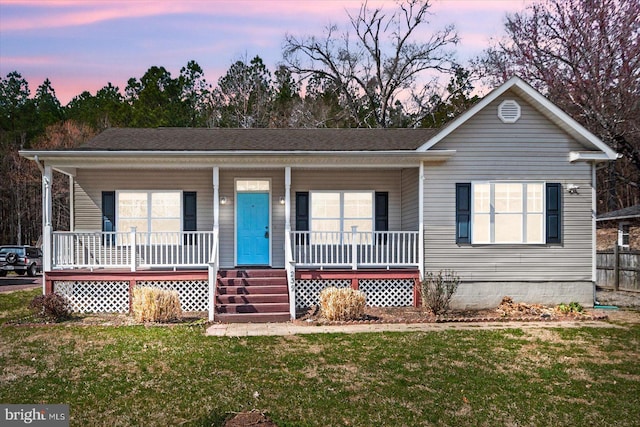 view of front of house with a lawn and covered porch