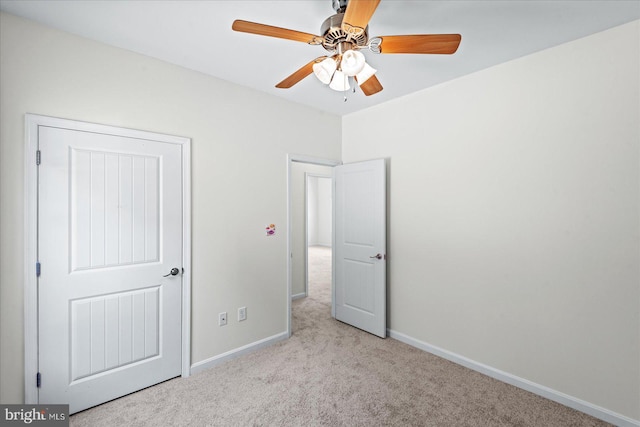 unfurnished bedroom with carpet flooring, baseboards, and ceiling fan