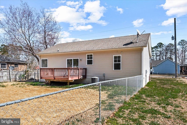 back of property with cooling unit, a fenced backyard, roof with shingles, and a wooden deck