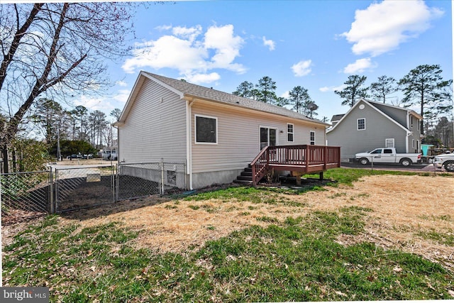 rear view of property featuring fence, a deck, and a gate