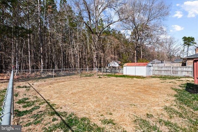 view of yard with a storage shed, a fenced backyard, and an outdoor structure