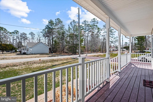 wooden terrace featuring covered porch