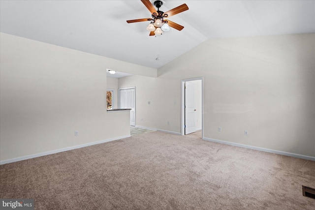 unfurnished room featuring carpet flooring, baseboards, a ceiling fan, and vaulted ceiling