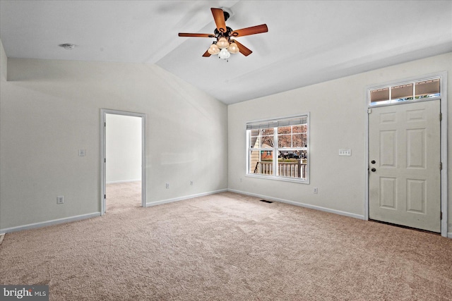 interior space with carpet, a ceiling fan, visible vents, baseboards, and lofted ceiling