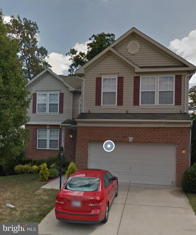 traditional home with a garage, brick siding, and concrete driveway