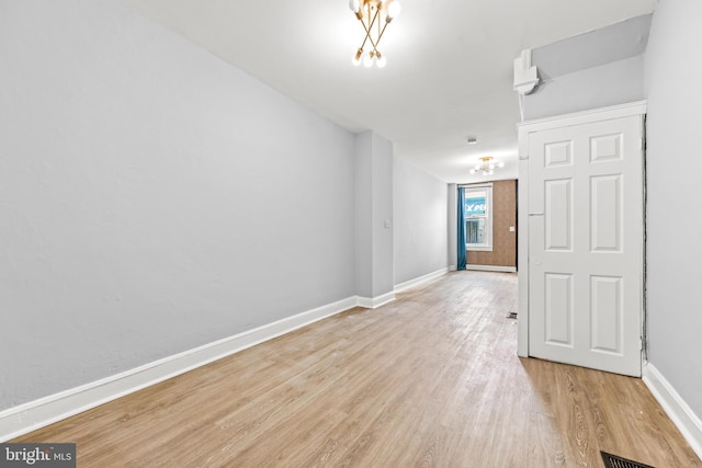 unfurnished room with light wood-style flooring and baseboards
