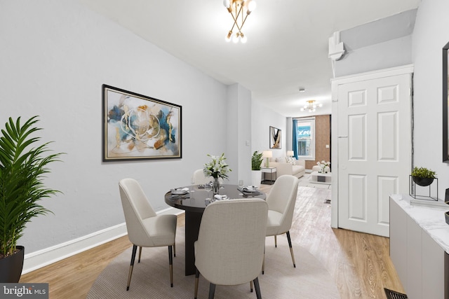 dining room with light wood-style flooring and baseboards