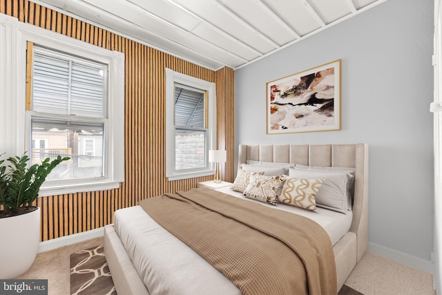 bedroom with baseboards and carpet