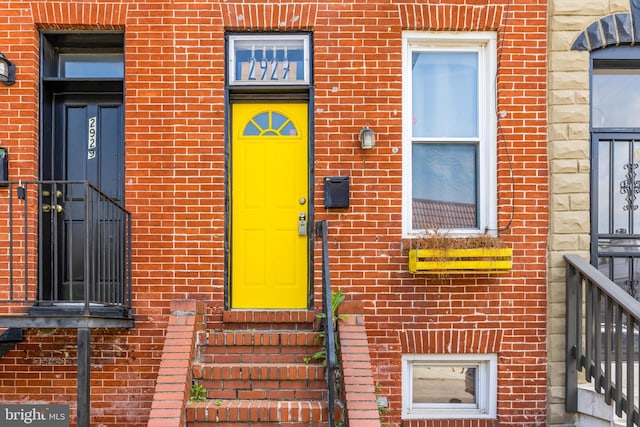 view of exterior entry with brick siding