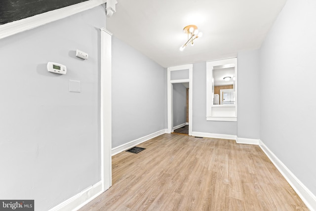 interior space with baseboards, visible vents, and light wood-style flooring