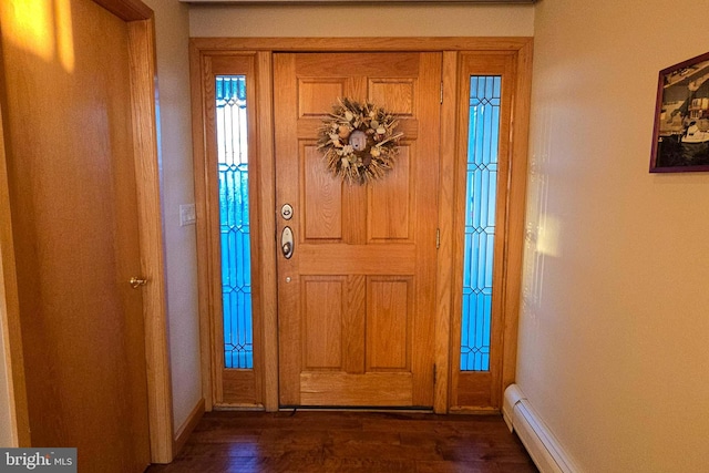 entrance foyer with a baseboard heating unit, baseboards, and dark wood finished floors