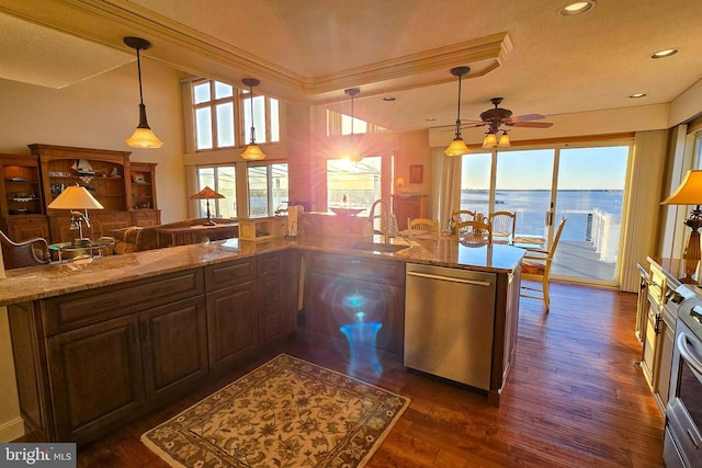 kitchen with ceiling fan, plenty of natural light, appliances with stainless steel finishes, and a sink