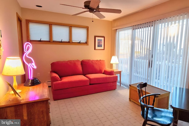 living room featuring baseboard heating and ceiling fan