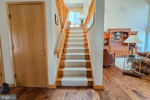 stairs featuring baseboards and hardwood / wood-style flooring