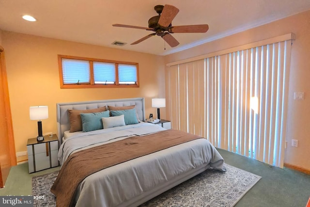 carpeted bedroom featuring visible vents, a ceiling fan, and baseboards